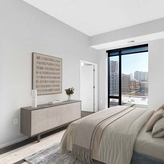 Thumbnail 6 of 12 A bedroom with a large bed and a view of the city.