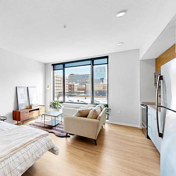 Thumbnail 9 of 10 A bedroom with a large bed and a view of the city.