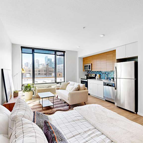 Thumbnail 6 of 10 A modern living room with a large window overlooking the city.