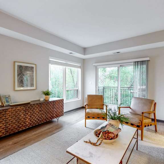Thumbnail 2 of 4 A living room with a couch, chairs, and a table.
