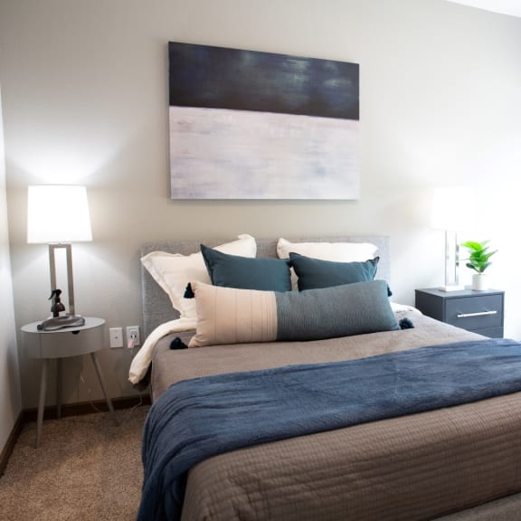 Thumbnail 3 of 4 a bedroom with a bed and a painting on the wall