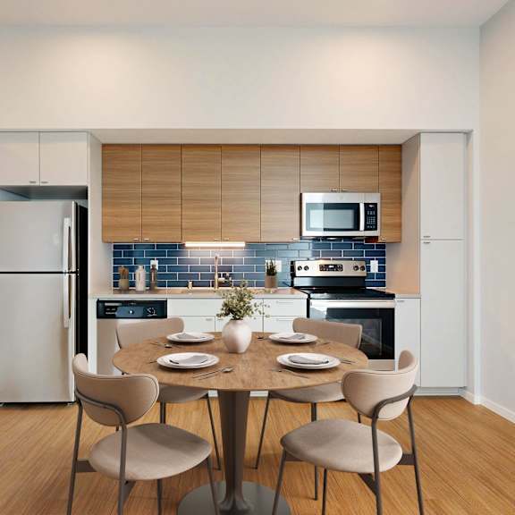 Thumbnail 5 of 6 A modern kitchen with a dining table set for four.