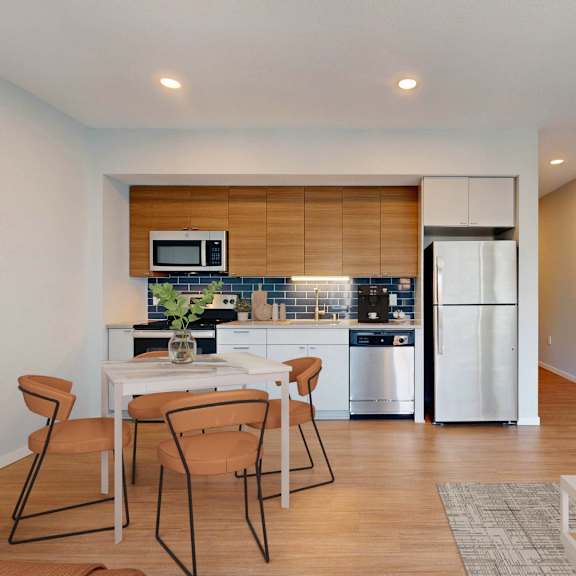 Thumbnail 3 of 6 A modern kitchen with a dining table and chairs.