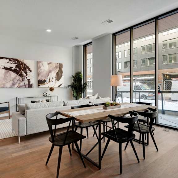 Thumbnail 5 of 7 A modern dining room with a table set for six.