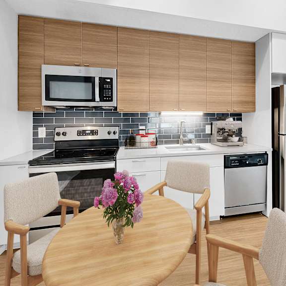 Thumbnail 3 of 8 A modern kitchen with a wooden table and chairs.