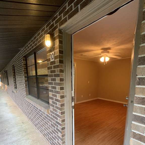 the living room of an empty house with a wood floor