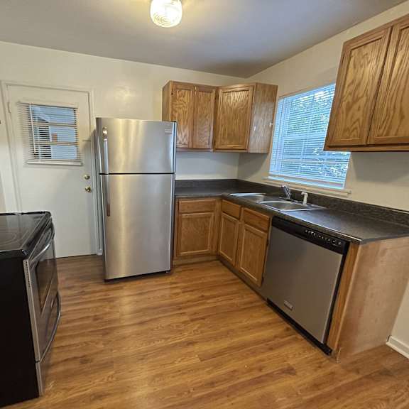 a kitchen with stainless steel appliances and wooden cabinets