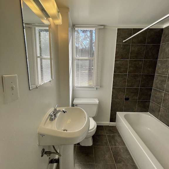 a bathroom with a sink toilet and a bath tub