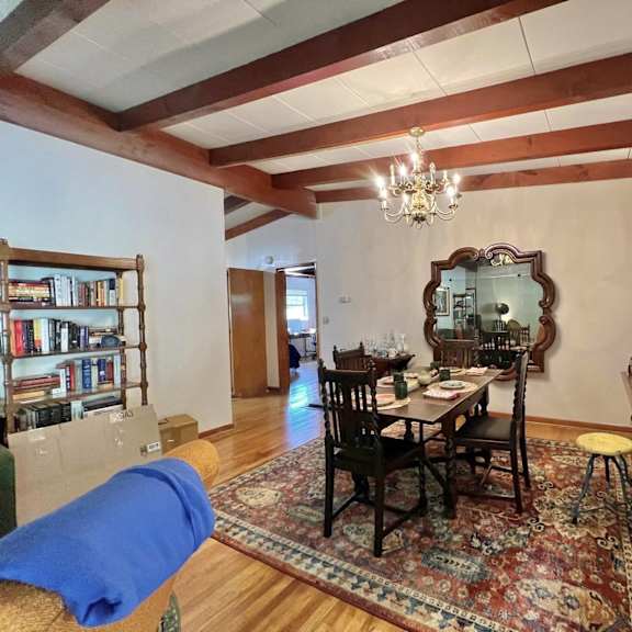a living room with a dining room table and a couch
