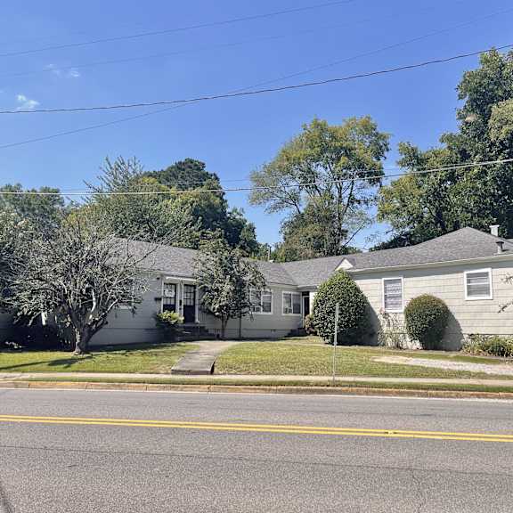 a white house on the corner of a street
