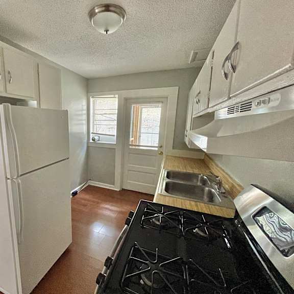 a kitchen with a stove and a refrigerator