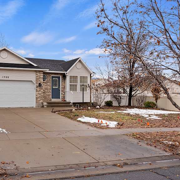 a house with a garage and a driveway in front.