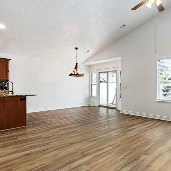 a room with wooden floors and a ceiling fan.