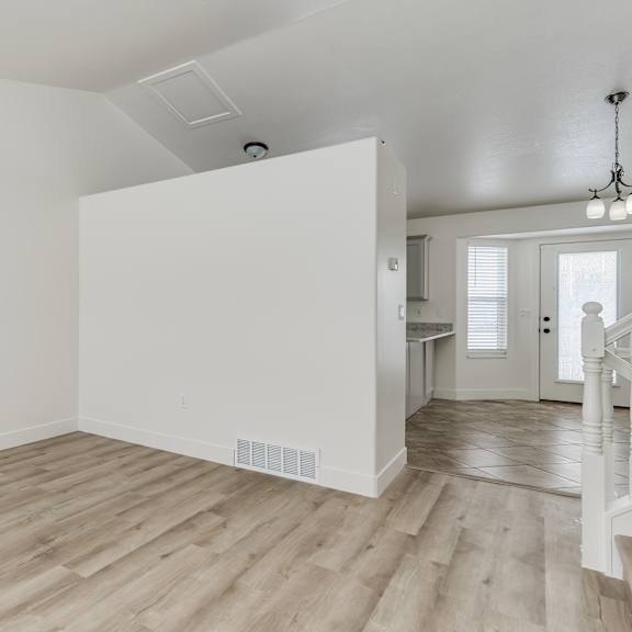 a room with wooden floors and white walls.