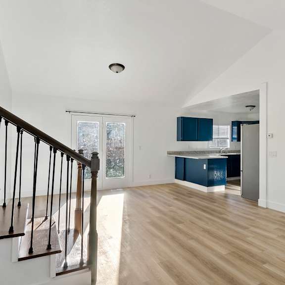 an empty living room and kitchen in a house