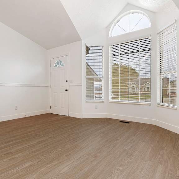 a room with a staircase and a door with a window.