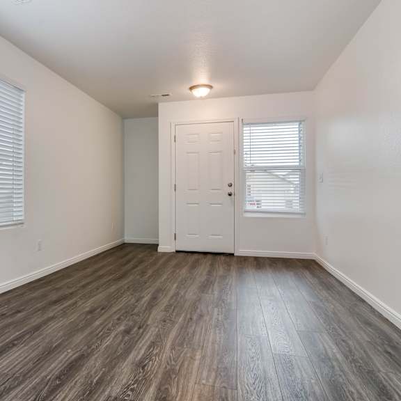 a room with a wooden floor and a white door.