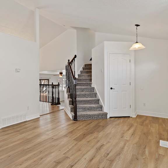 a room with a staircase and a chandelier.