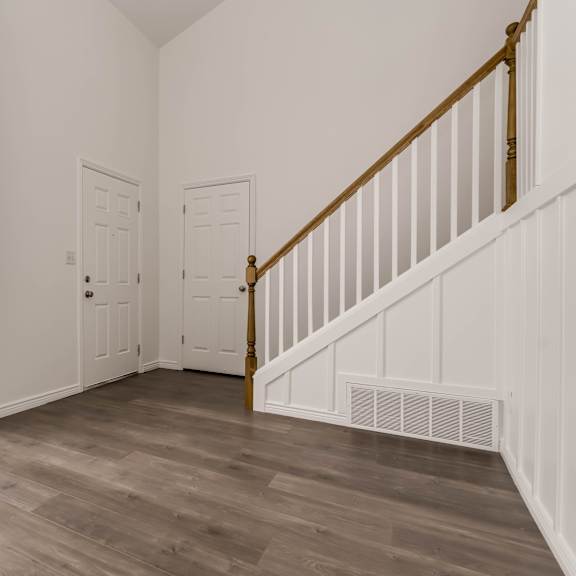 a room with a staircase and a window.