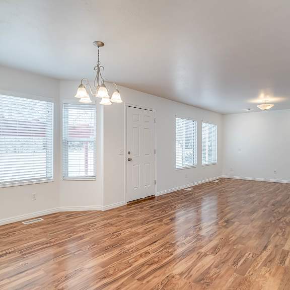 a room with wooden floors and white walls.