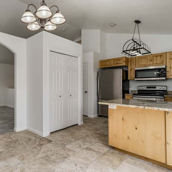 a kitchen with a wooden island and a white door.