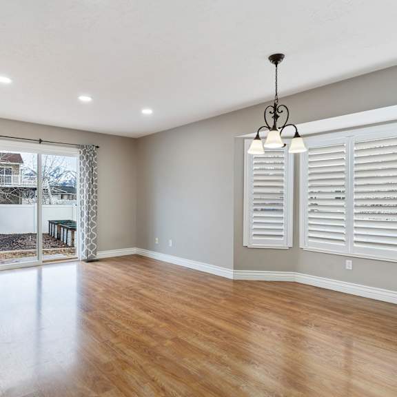 a room with wooden floors and white walls.