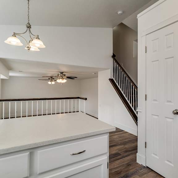 a kitchen with white cabinets and a stainless steel refrigerator.
