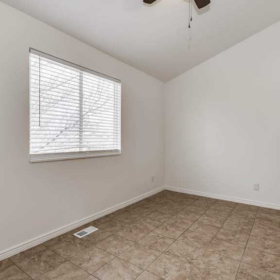 a room with a window and a tile floor.