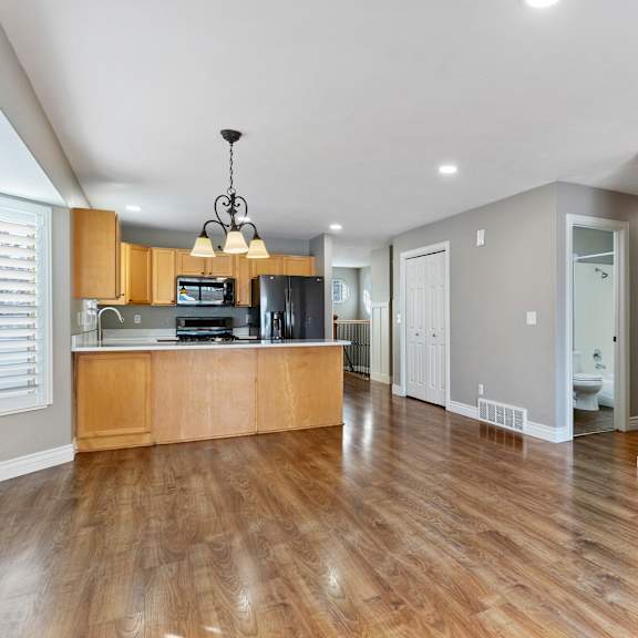 a kitchen with wooden floors and a wooden island.