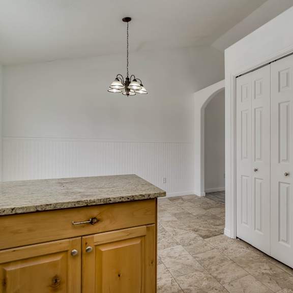 a white door is in a room with a marble counter top.