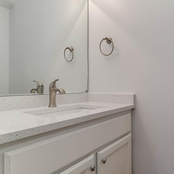 a bathroom with a white sink and a mirror above it.