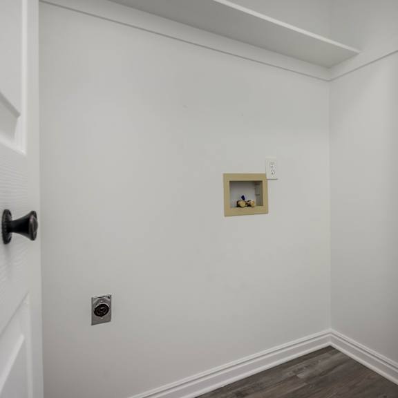 a white door with a black handle is on the left side of the image.