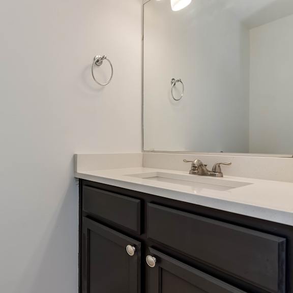 an empty bathroom with a sink and a mirror