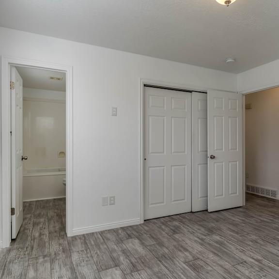 a room with a white door and a window with blinds.
