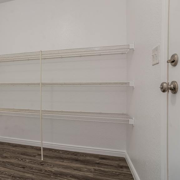 empty room with shelves and wooden floor.