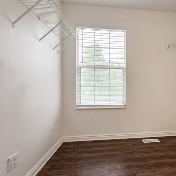 an empty room with white walls and a window