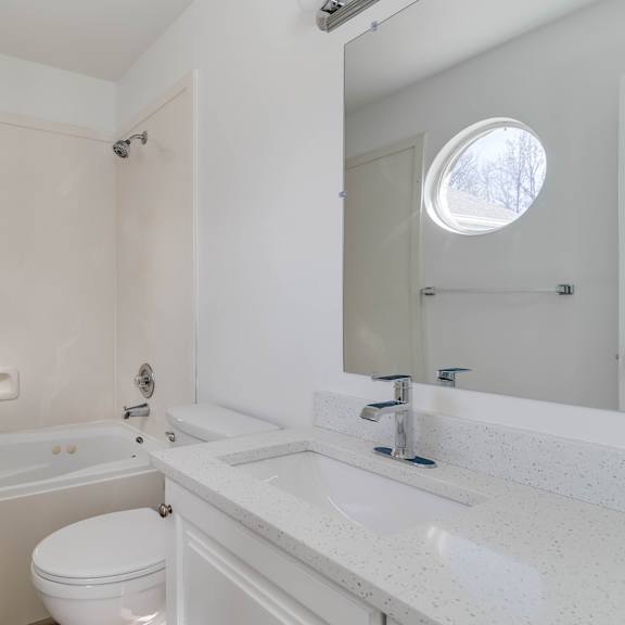 a bathroom with a sink toilet and a bath tub