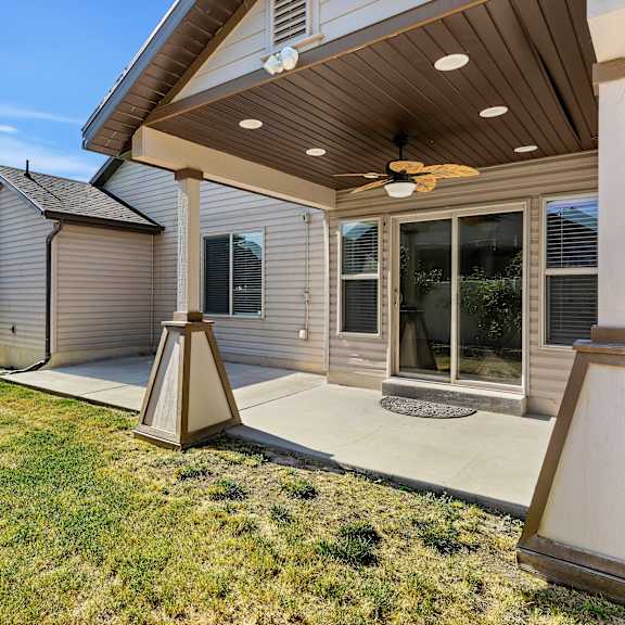 a house with a patio and a ceiling fan.