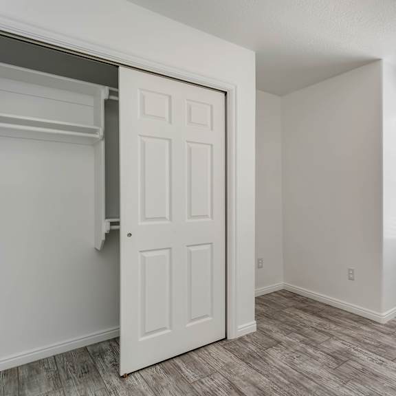 a white door is open to a room with a window.