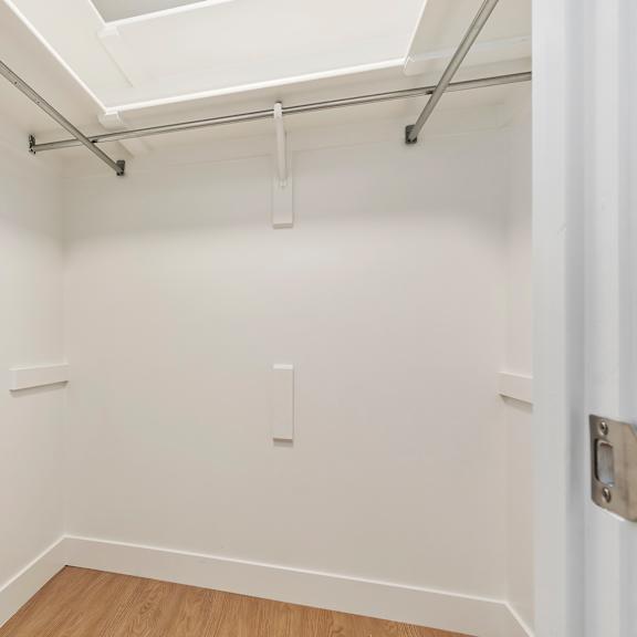 a white room with a skylight and wood flooring.