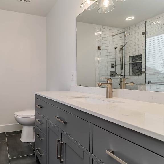 a white toilet is in a bathroom with a white tile shower.