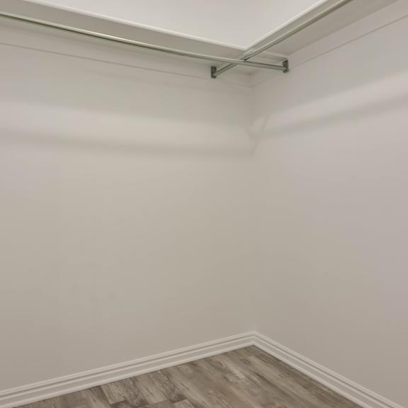 a room with a white wall and a wooden floor.