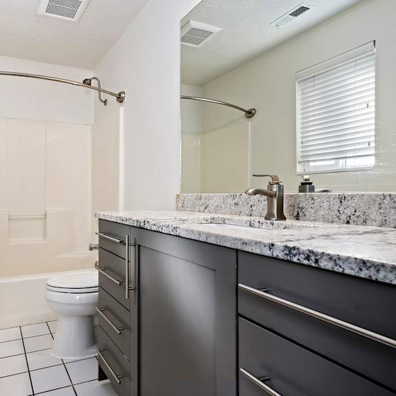 a bathroom with a toilet and a sink and a shower
