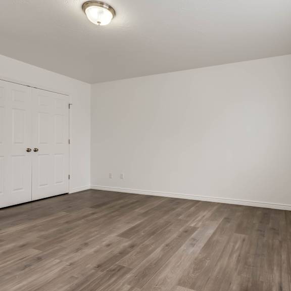 a room with a white door and a window with blinds.