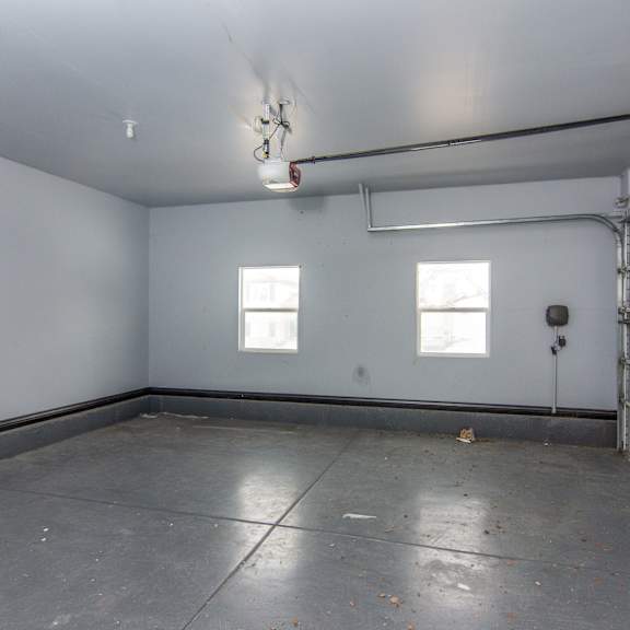 the interior of a garage with white walls and white garage doors
