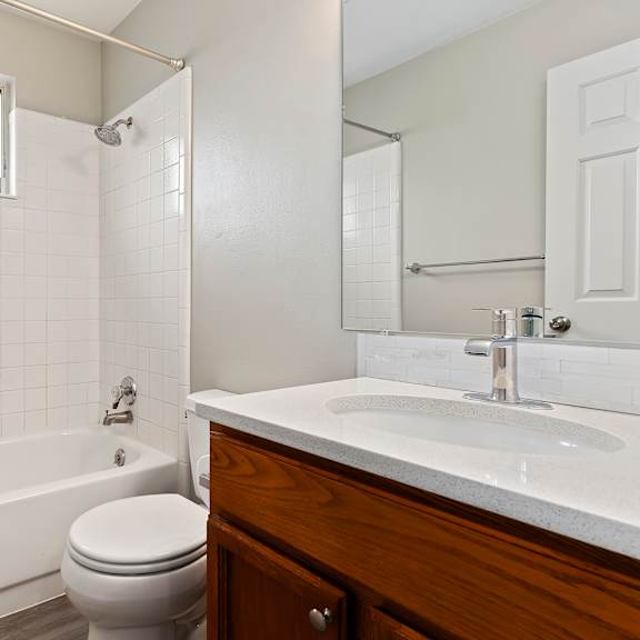 an empty bathroom with a toilet sink and bath tub