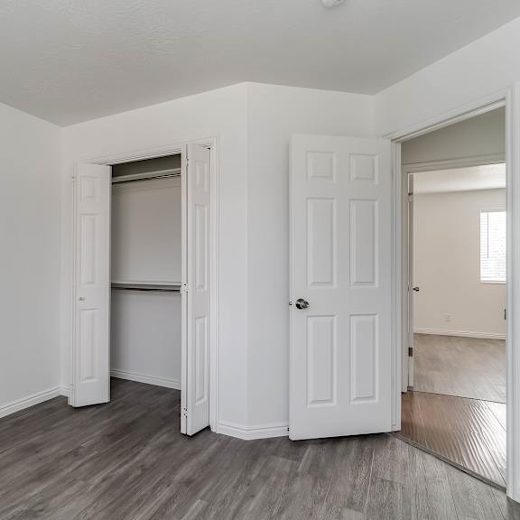 a room with a white door and a grey floor.