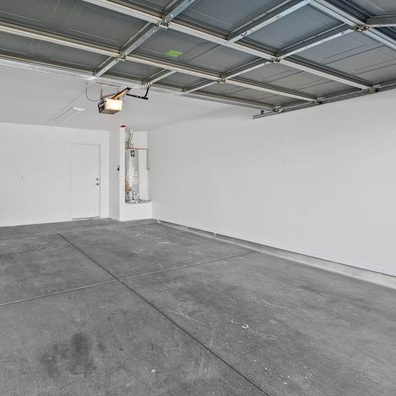a large room with a concrete floor and white walls