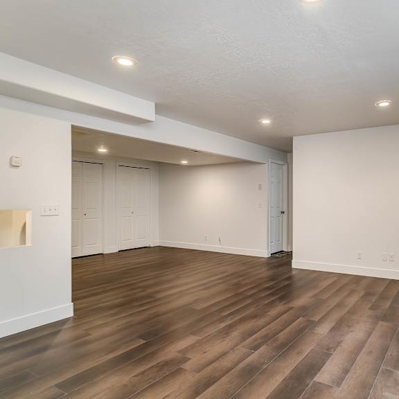 a room with wooden floors and white walls.