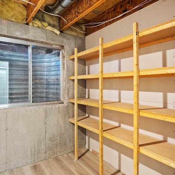 a room with empty shelves and a window